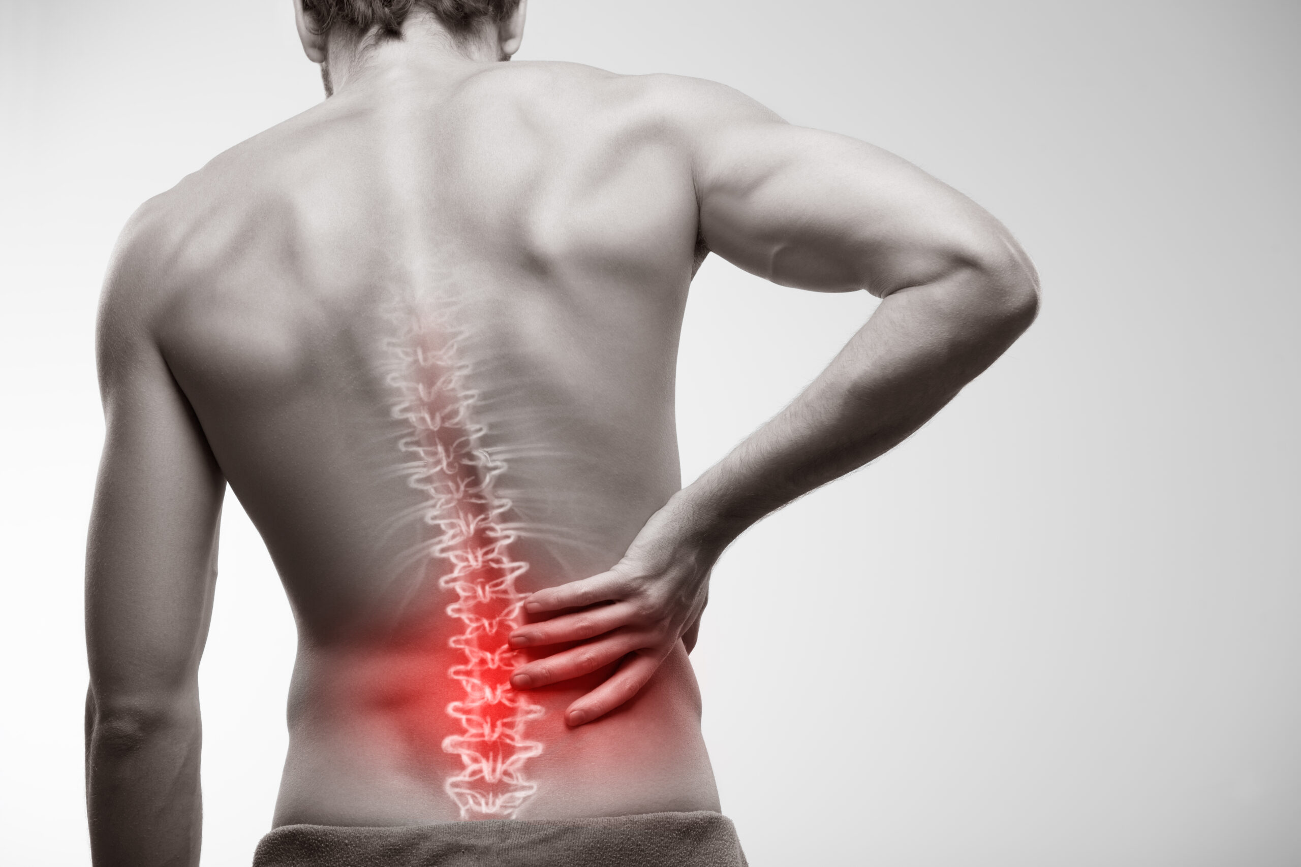 A physiotherapist in Drogheda treats a patient with lower back pain using manual therapy techniques in a bright, modern clinic environment.